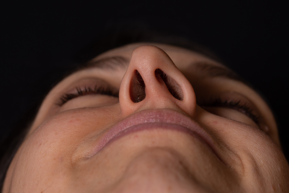 Detail of woman face seen in perspective, showing deviated nasal septum
